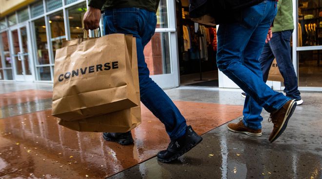 A shopper carries multiple bags